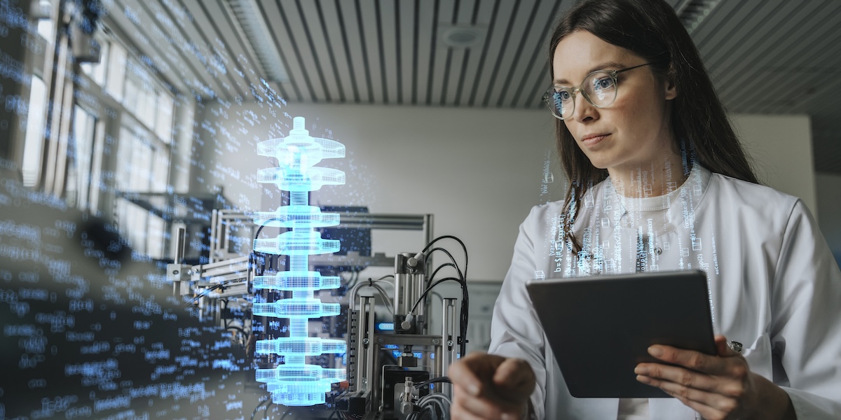 Female engineer with digital tablet examining development of industrial product